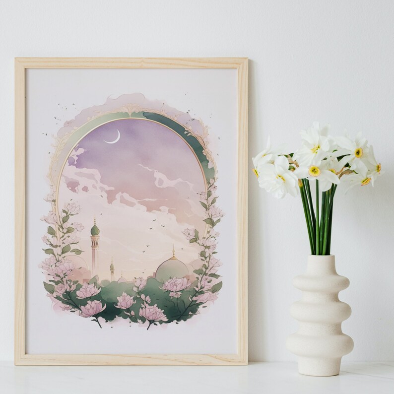 May include: A framed print with a watercolor illustration of a mosque with a crescent moon in the sky. The mosque is surrounded by pink flowers and greenery. The background is a soft purple and pink.