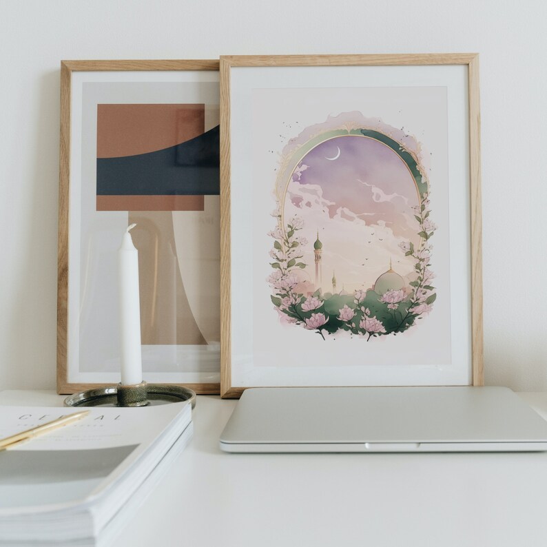 May include: A framed print of a watercolor painting depicting a mosque with a crescent moon in the sky. The mosque is surrounded by pink flowers and greenery. The painting is set against a light pink background.