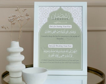 May include: A framed print with a green background and white border. The print features Arabic text and English translations for duas to say during Ramadan. The text reads "Ramadan", "Du'a for Starting Your Fast", "Du'a for Breaking Your Fast", and the Arabic text for each dua.