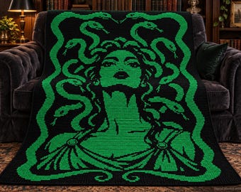 May include: A rectangular crochet blanket featuring a black background with a vibrant green pixelated graphic of Medusa. The design depicts a central figure with snakes for hair, framed by a border of intertwined snakes, rendered in a grid-like pattern.