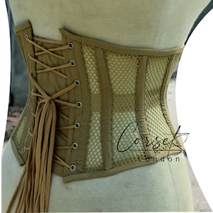 May include: A tan corset with a mesh panel and a lace-up back. The corset is made of a sturdy fabric and has a classic design.