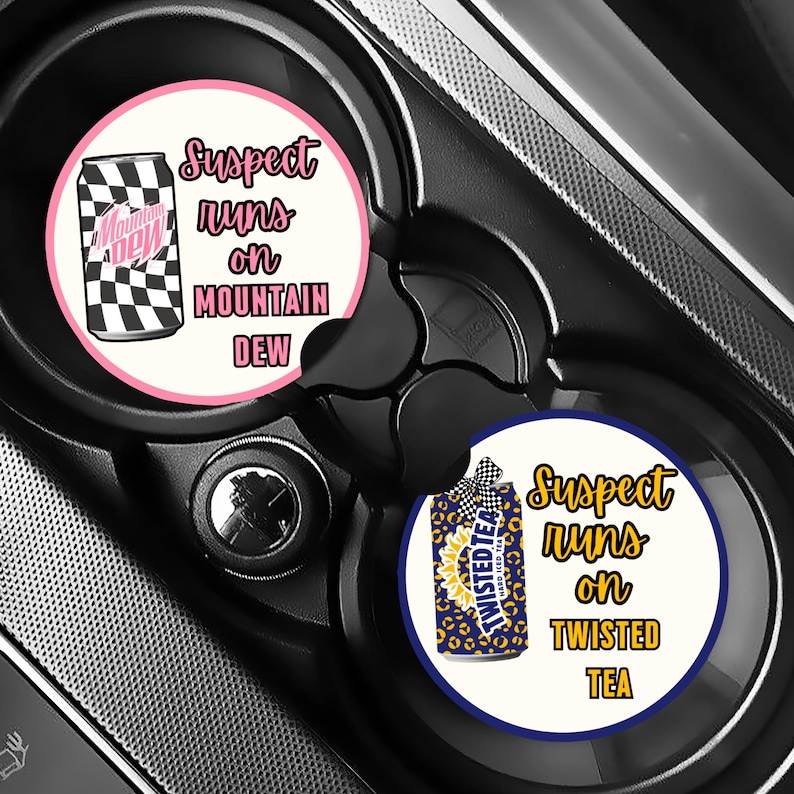 May include: Two car coasters with the text "Suspect runs on MOUNTAIN DEW" and "Suspect runs on TWISTED TEA". One coaster features a Mountain Dew can with a black and white checkered pattern. The other has a Twisted Tea can.