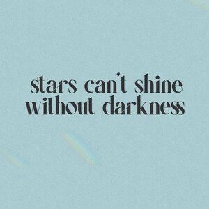 May include: A light blue background with the text "stars can't shine without darkness" in a serif font. The text is in black. The background has a subtle, textured appearance.