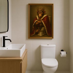 May include: A framed painting of a monkey wearing a crown and a red robe sitting on a toilet.