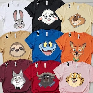 May include: A collection of nine colorful t-shirts featuring cartoon character faces. The shirts are in various colors, including white, black, tan, blue, orange, maroon, red, and pink. Each shirt has a different animal face design, perfect for fans of animated movies.