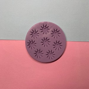 May include: Purple silicone mould with eight star-shaped impressions. The mould is designed for making small resin crafts.