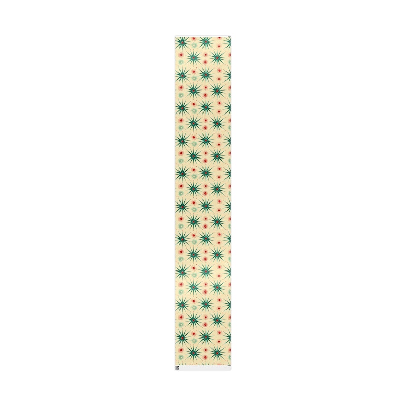 May include: A rectangular table runner with a repeating pattern of green starbursts and small red dots on a cream background. The runner is made of a soft, durable fabric.