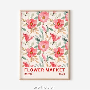 May include: A framed print with a watercolor floral pattern in shades of pink and green. The print has the text "FLOWER MARKET" in red, "MADRID" in black, and "SPAIN" in black.
