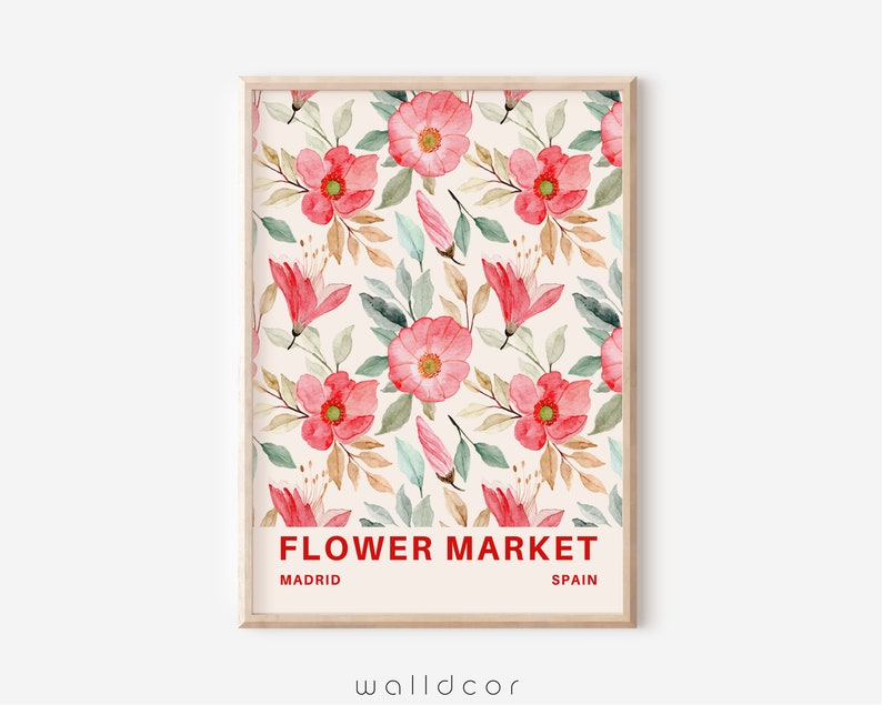 May include: A framed print with a watercolor floral pattern in shades of pink and green. The print has the text "FLOWER MARKET" in red, "MADRID" in black, and "SPAIN" in black.