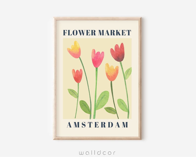 May include: A framed art print featuring a watercolor illustration of colorful tulips. The flowers are in shades of red, pink, and yellow, with green stems and leaves, set against a cream background. The text "FLOWER MARKET AMSTERDAM" is displayed in navy blue.
