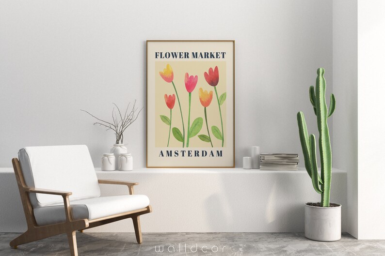 May include: A framed art print featuring a watercolor illustration of tulips in shades of red, pink, and yellow, with green stems and leaves. The text "FLOWER MARKET AMSTERDAM" is displayed in navy blue.