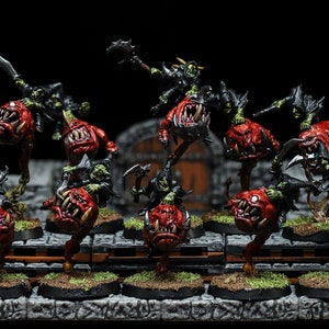 May include: A group of nine green and red goblin miniatures riding on the backs of grotesque, red, snarling creatures. The goblins are holding weapons and are posed in a variety of fighting stances.