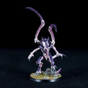 May include: A purple and white detailed miniature of a creature with multiple limbs and a long tail. The creature is standing on a round base with green and brown accents.