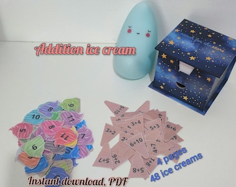 May include: A collection of educational materials for children. Includes colorful ice cream cone cutouts with numbers, addition problems, and the text "Addition ice cream" and "Instant download, PDF". Also features a blue night light and a star-themed box.