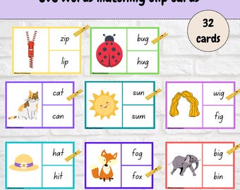 May include: A set of 32 CVC words matching clip cards featuring colorful illustrations of a zipper, ladybug, cat, sun, wig, hat, fox, and elephant. Each card displays a picture and two word options, with wooden clips attached to the correct answers.