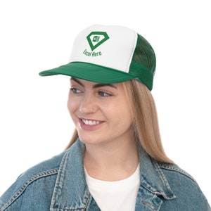 May include: A white and green trucker hat with a green diamond logo that says "Excel Hero" and a green spreadsheet icon inside the diamond.