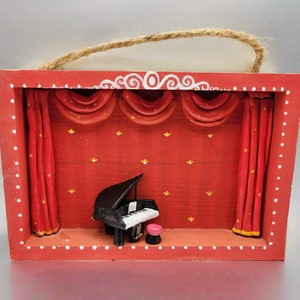 Clay miniature of Piano on a shadow box