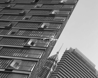 May include: A black and white photo of two tall buildings with a geometric design. The buildings are made of glass and steel and have a modern look.