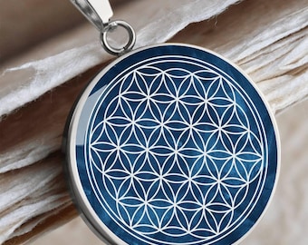 May include: A silver necklace with a round pendant featuring a blue and white flower of life design.