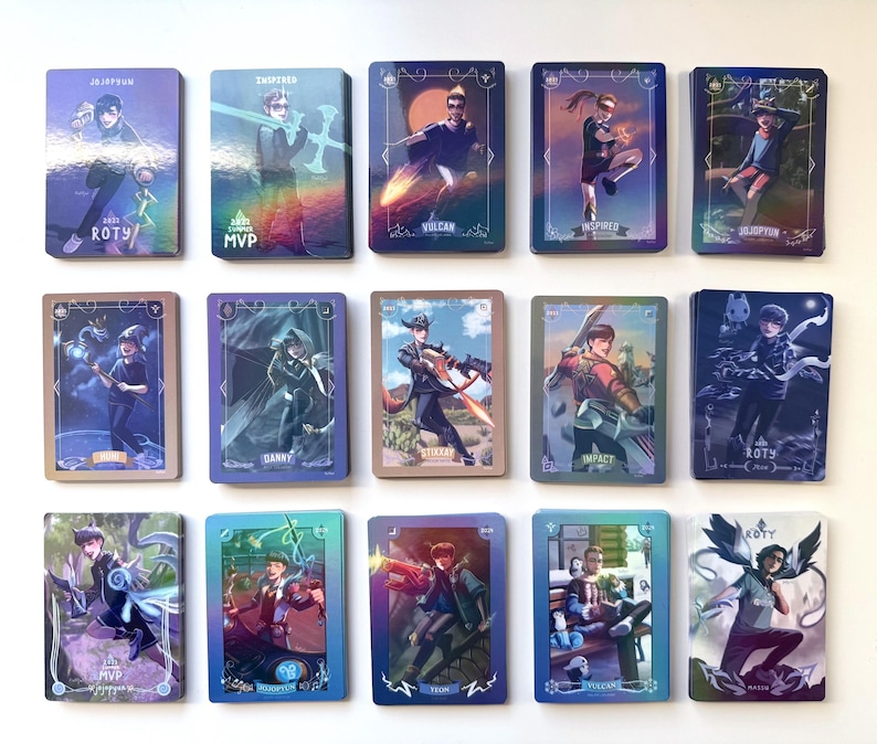 A set of 15 holographic trading cards featuring colorful illustrations of various North American League of Legends esports LCS professional players. The cards depict the players in dynamic poses as their favorite or iconic champions from different years. The cards have borders based on the player's team colors.
