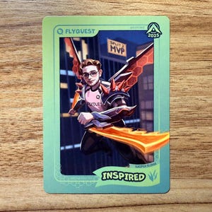 A trading card featuring lolesports LCS and LEC professional player Kacper Słoma, aka Inspired, in the FlyQuest 2025 pink jersey. He is drawn leaping in a cityscape as Mecha Kha'Zix, one of his favorite League of Legends champions, with red wings and orange reaper claws. 'SPLIT 2 MVP' is written in the background. The card has a green gradient border with text "INSPIRED" and Jungle icon at bottom right, 'MECHA KHA'ZIX' bottom left, the LTA North logo top right, and the FLYQUEST logo top left.