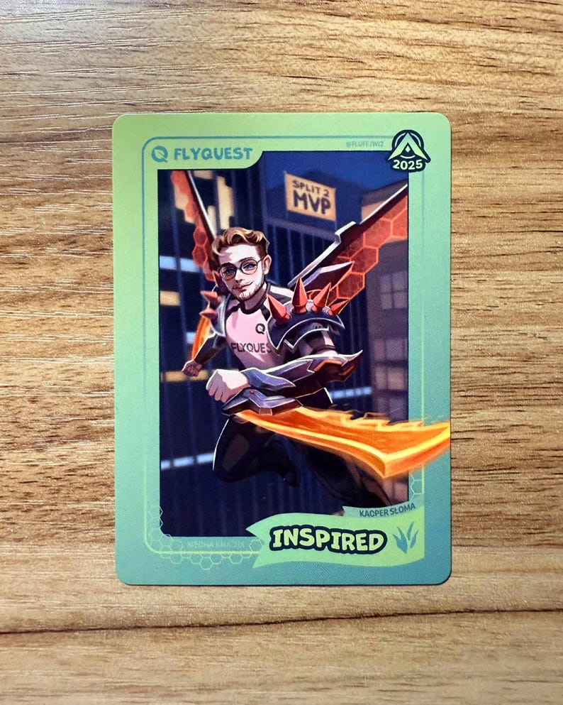 A trading card featuring lolesports LCS and LEC professional player Kacper Słoma, aka Inspired, in the FlyQuest 2025 pink jersey. He is drawn leaping in a cityscape as Mecha Kha'Zix, one of his favorite League of Legends champions, with red wings and orange reaper claws. 'SPLIT 2 MVP' is written in the background. The card has a green gradient border with text "INSPIRED" and Jungle icon at bottom right, 'MECHA KHA'ZIX' bottom left, the LTA North logo top right, and the FLYQUEST logo top left.