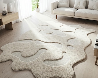 Tapete de lã tufado à mão em tom off-white com formato irregular e formas orgânicas abstratas para sala de estar.