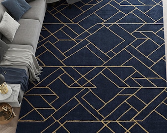May include: A navy blue rug with a geometric pattern of gold lines. The rug has a modern design and would look great in a living room or bedroom.