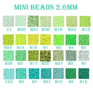 May include: A chart of 2.6 mm mini beads in various shades of green, yellow, and white. The beads are arranged in rows and columns, with each color labeled with a letter and number code. The text "MINI BEADS 2.6MM" is at the top of the chart.