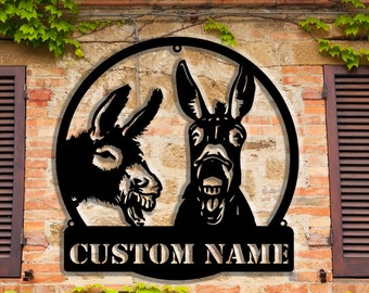 May include: Black metal wall sign with two donkey silhouettes. One donkey is looking to the left and the other is looking to the right with its mouth open. The sign has a custom name plate at the bottom that says "CUSTOM NAME".