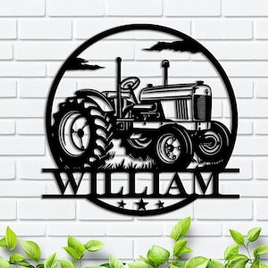 May include: Black metal silhouette of a tractor with the name "William" underneath. The tractor is in a circle with a background of clouds and grass.