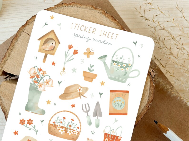 May include: A sticker sheet with a spring garden theme. The sheet features illustrations of a birdhouse, flowers, a watering can, a gardening hat, a basket of flowers, gardening tools, and a seed packet. The text "STICKER SHEET Spring Garden" is at the top.