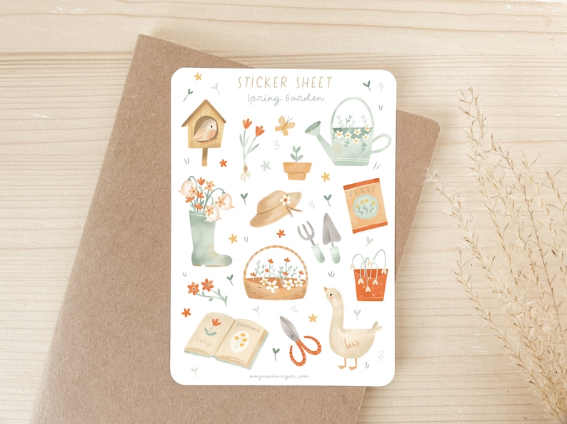 May include: A sticker sheet with a spring garden theme. The sheet features illustrations of gardening tools, flowers, a birdhouse, a watering can, a goose, and the text "Spring Garden". The color palette includes soft greens, oranges, and browns.