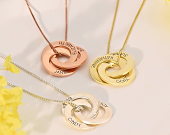 May include: Three gold, silver, and rose gold intertwined circle necklaces with engraved names. The names on the gold necklace are "Summer", "Katherine", and "Dora". The names on the silver necklace are "Adele", "Belle", and "Cindy". The names on the rose gold necklace are "Boy", "Elizabeth", and "Jane".
