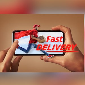 May include: A person holding a smartphone with a red cape and a box in their hands. The phone screen shows a person running with a red cape and a box in their hands. The text "Fast Delivery" is on the screen.