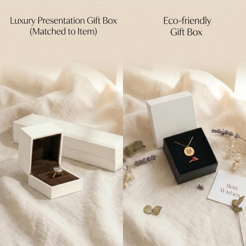 May include: A white rectangular luxury presentation gift box with a brown interior containing a ring, and a white square eco-friendly gift box with a black interior containing a gold necklace and a ring, accompanied by a card reading Best Wishes.