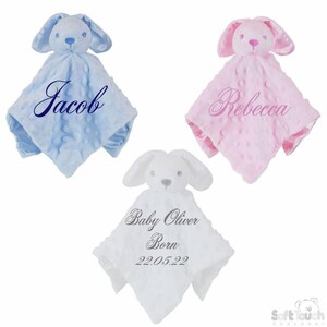 May include: Three personalised baby blankets featuring bunny rabbit heads. The blankets are blue, pink and white. The blue blanket has the name "Jacob" embroidered on it. The pink blanket has the name "Rebecca" embroidered on it. The white blanket has the text "Baby Oliver Born 22.05.22" embroidered on it.