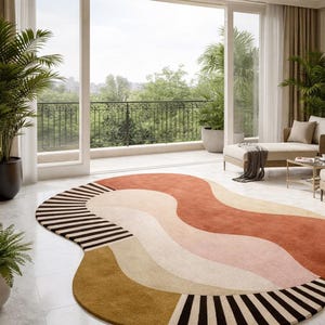 May include: A large, abstract area rug with a wavy design in shades of rust, pink, beige, and mustard yellow. The rug features black and white striped accents on the edges, adding a modern touch to the room's decor.
