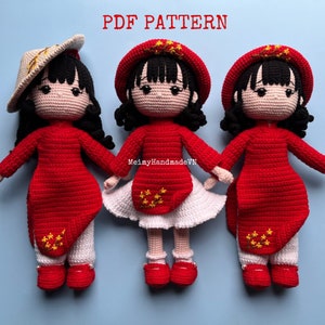 May include: Three crocheted dolls wearing traditional Vietnamese clothing. The dolls are dressed in red ao dai with white pants and a white skirt. The dolls have black hair and are wearing red hats with yellow stars. The dolls are standing on a light blue background. PDF PATTERN