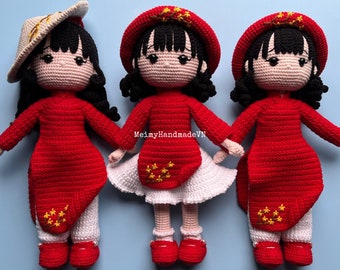 May include: Three crocheted dolls wearing traditional Vietnamese clothing. The dolls are dressed in red ao dai with white pants and a white skirt. The dolls have black hair and are wearing red hats with yellow stars. The dolls are standing on a light blue background. PDF PATTERN