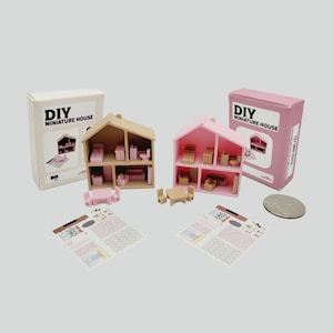 May include: Two pink and brown miniature DIY houses with furniture and instructions. The houses are on a white background.