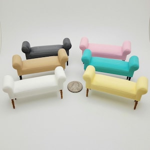 May include: Miniature benches in various colors: white, tan, gray, pink, teal, and yellow. Each bench has a rectangular seat, curved armrests, and four brown legs. A quarter is included for size reference. These benches are likely for a dollhouse or similar project.