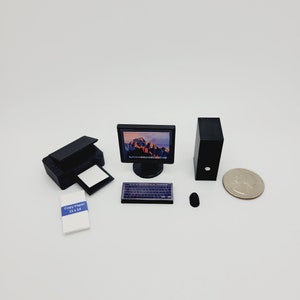 May include: A miniature black desktop computer set with a monitor, tower, keyboard, mouse, printer, and a stack of copy paper labeled "Copy Paper 11 x 14".
