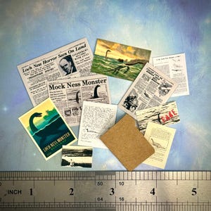 May include: Miniature ephemera featuring Loch Ness Monster illustrations and newspaper clippings. Includes a postcard with "Loch Ness Monster Scotland" text, and a ruler showing inches. A brown rectangle is also present.