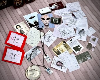 May include: A collection of miniature items related to extraterrestrial themes, including red X-File folders, drawings of aliens, FBI badges, and a silver coin. Various documents and illustrations are scattered around the scene.