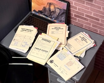 May include: A miniature office desk setup featuring a laptop displaying a mountain landscape, a black chair, and several manila folders labeled Police Department Homicide Case File, Special Investigation File, and Evidence Chain of Custody.