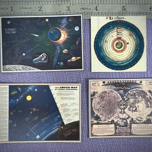 May include: Four vintage space maps, each with a different theme. The top left map is black with white stars and planets, and the text "Astronauts Space Map". The top right map is a blue and white circle with the text "Le J.liure". The bottom left map is black with white stars and planets, and the text "The Amoco Map of Space Mysteries". The bottom right map is a black and white illustration of the moon with the text "Myths Ways & Myths Moons".