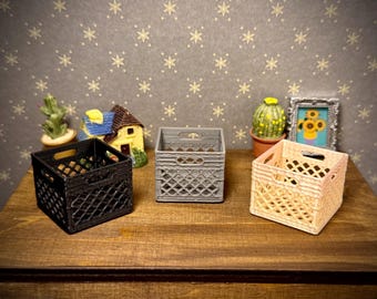 May include: Three miniature square storage crates in black, gray, and light peach colors. Each crate features a diamond-patterned lattice design on the sides, a hollow interior, and integrated handles on the top edges of two opposing sides.