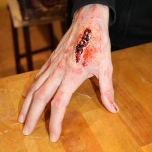 Latex Hand Wound Prosthetic Appliance. Film TV Theatre Prosthetics. SFX Make-Up. Halloween make-up. Cut. Cosplay.