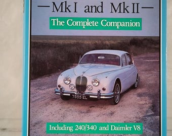 May include: A blue book cover with the title "JAGUAR - MkI and MkII - The Complete Companion" and a white Jaguar sedan on the cover. The book includes information about the 240/340 and Daimler V8 models. The author is Nigel Thorley.